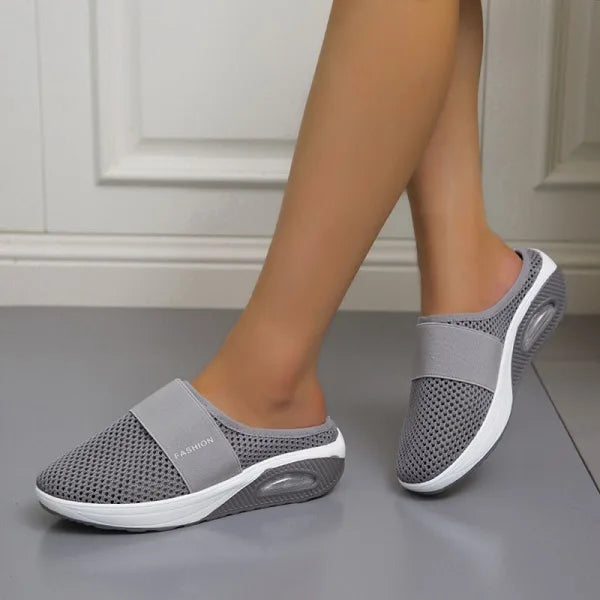 Dark grey backless slip-on knit sneakers with elastic collar and oval sole detail