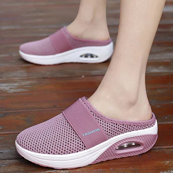 Pink backless slip-on knit sneakers with white sole and oval window detail