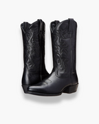 Black cowboy boots with embossed floral stitching and block heel