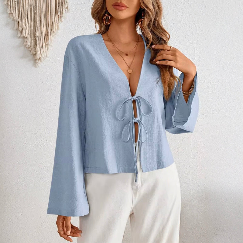 Women's deep V-neck bell sleeve top in light blue with bow-tie front