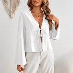 Women's deep V-neck bell sleeve top in white with bow-tie front