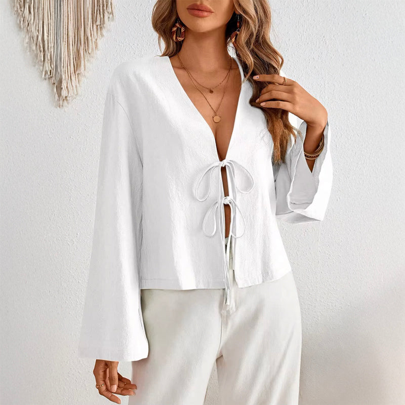 Women's deep V-neck bell sleeve top in white with bow-tie front