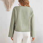 Women's deep V-neck bell sleeve top back view in sage green