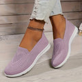 Purple low-top slip-on sneakers with textured knit upper and white rubber sole.