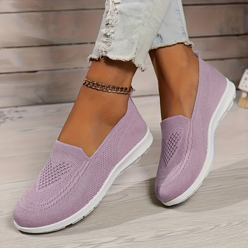 Purple low-top slip-on sneakers with textured knit upper and white rubber sole.