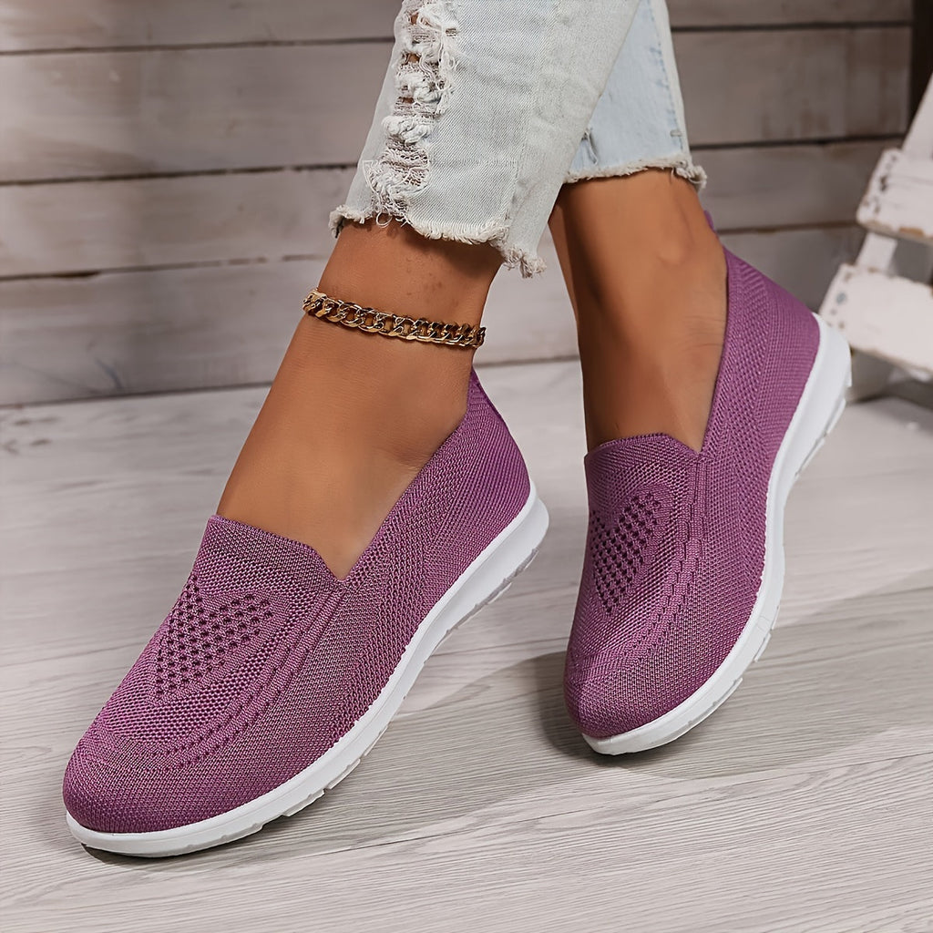 Fuchsia low-top slip-on sneakers with textured knit upper and white rubber sole.