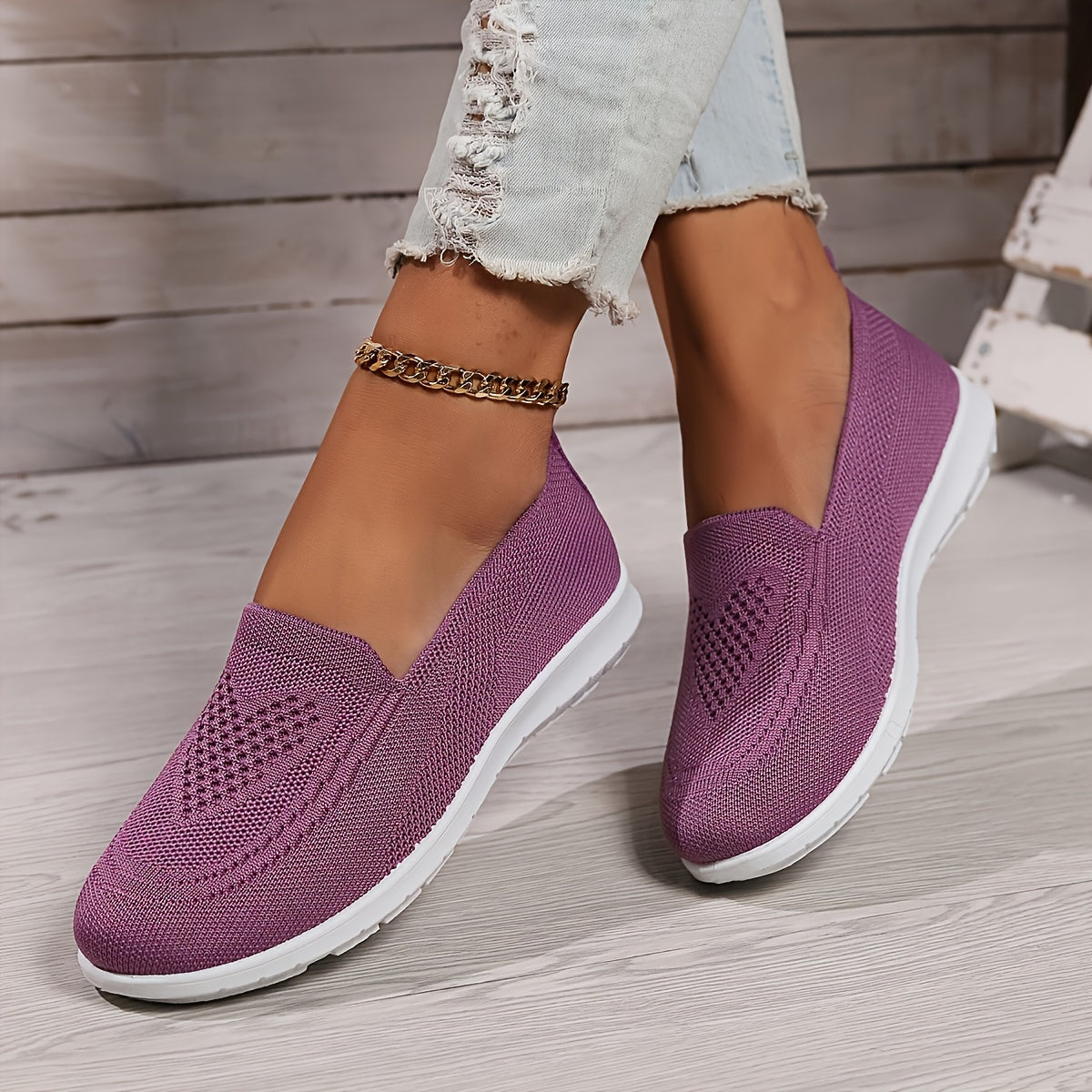 Fuchsia low-top slip-on sneakers with textured knit upper and white rubber sole.