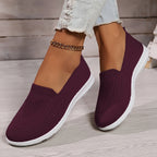 Dark purple low-top slip-on sneakers with textured knit upper and white rubber sole.