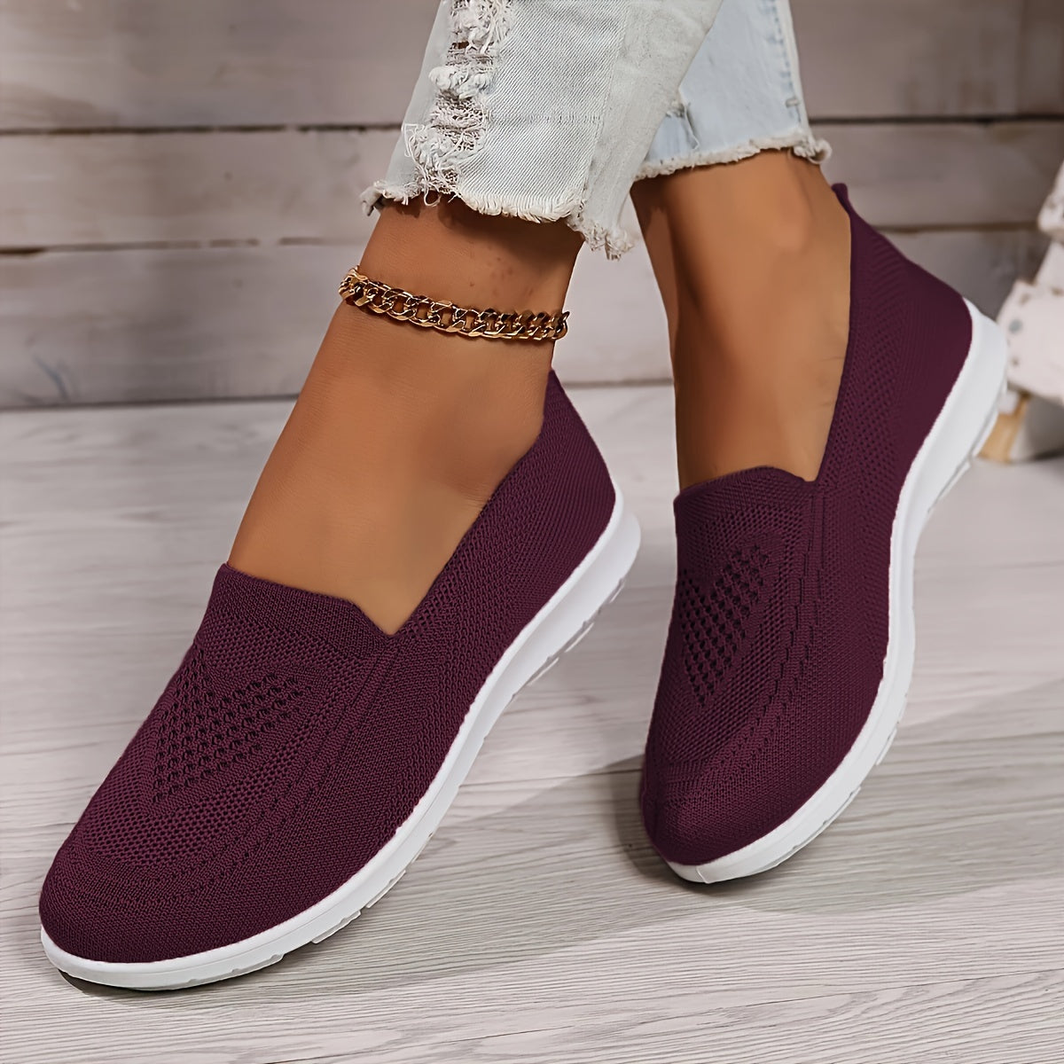 Dark purple low-top slip-on sneakers with textured knit upper and white rubber sole.