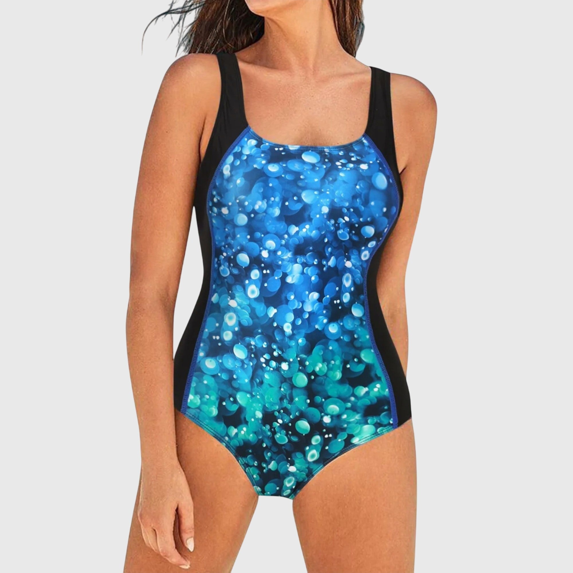 Square-neck one-piece swimsuit, turquoise and blue dot print on dark base with straps