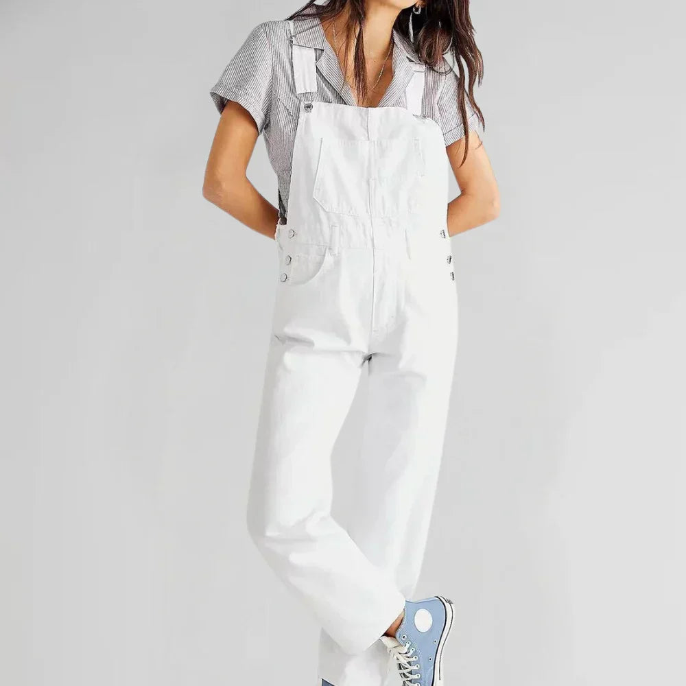 White denim jumpsuit with square neckline, bib front, and front pocket details