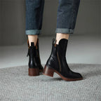 Black ankle boots with block heel and side zipper detail, tassel pull
