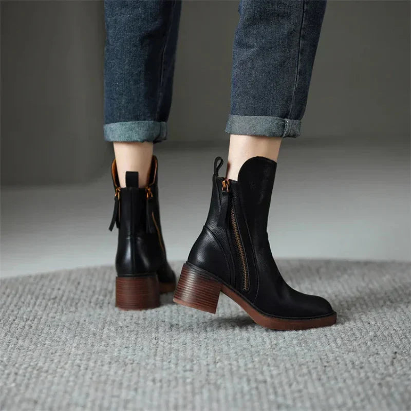 Black ankle boots with block heel and side zipper detail, tassel pull