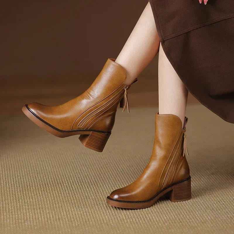 Brown ankle boots with block heel and side zipper detail, tassel pull