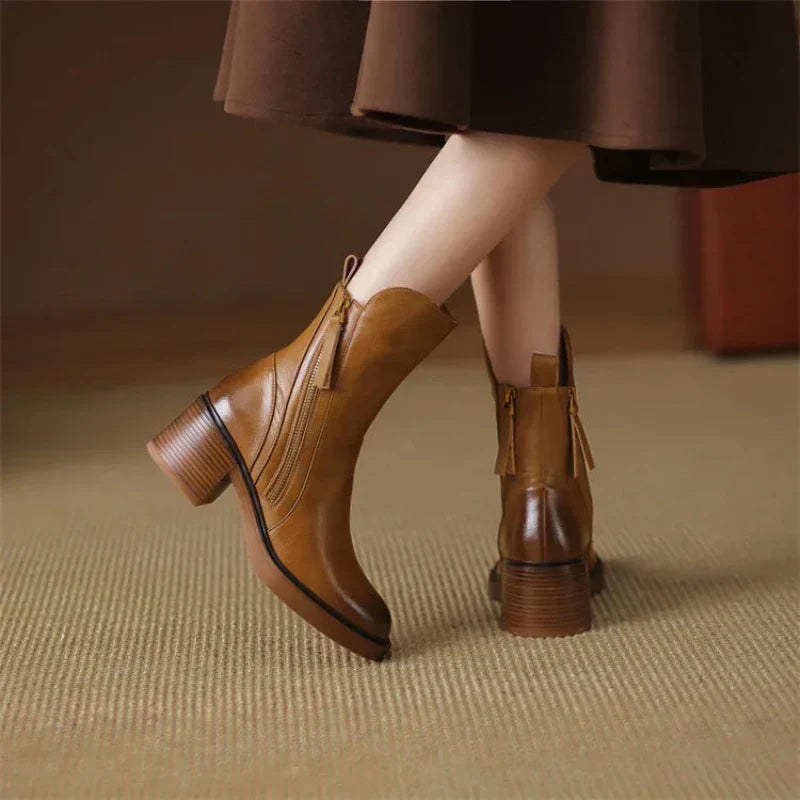 Brown ankle boots with block heel and side zipper detail, back view