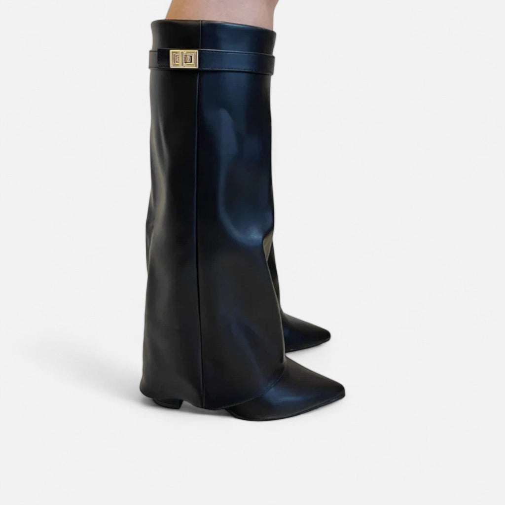 Black knee-high suede boots with buckled strap and pointed toe, low heel