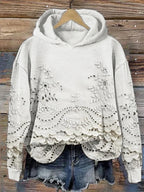White floral-embroidered hoodie with scalloped lace hem.