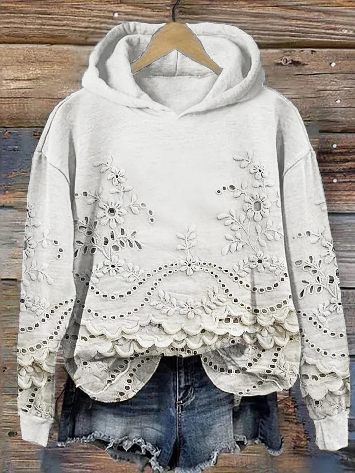 White floral-embroidered hoodie with scalloped lace hem.