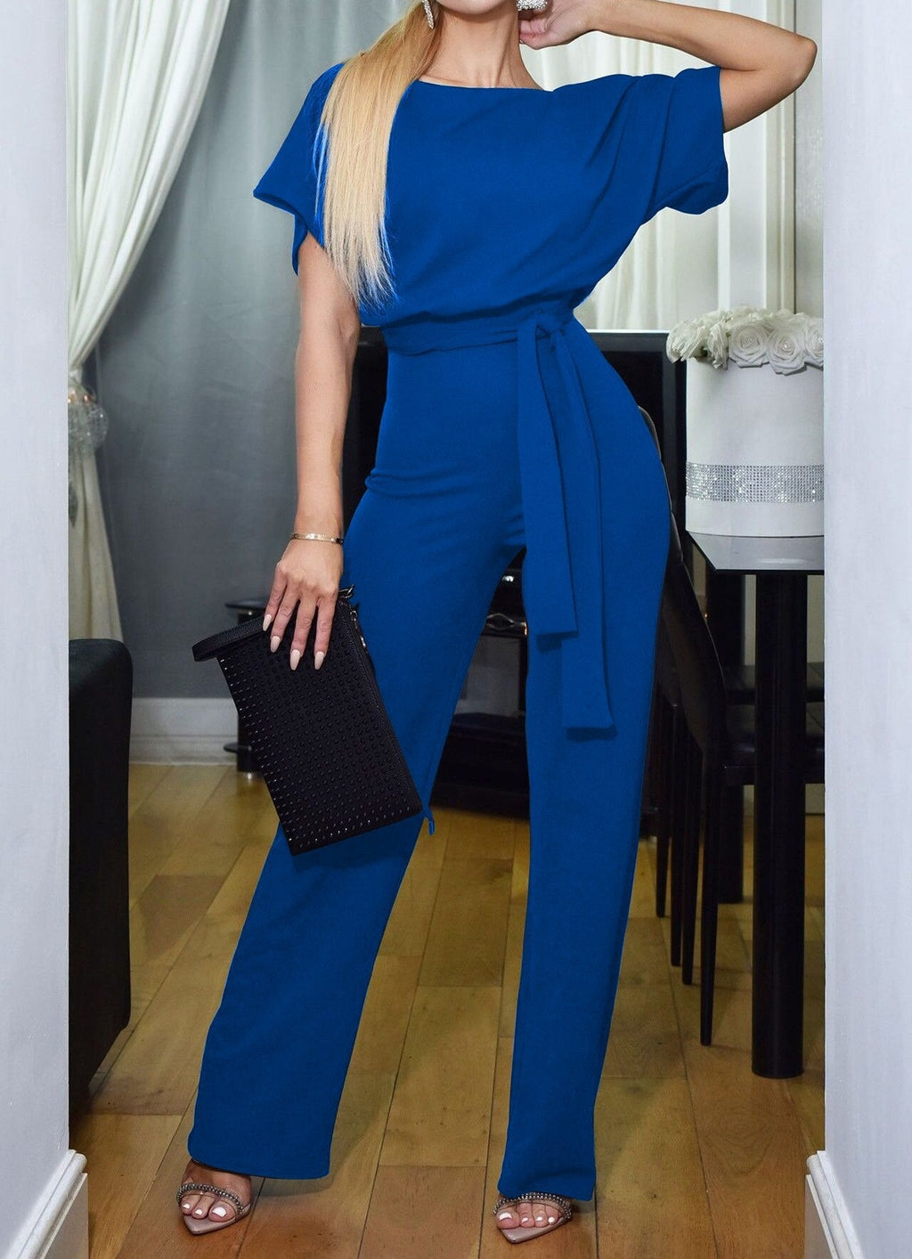 Blue high-waist jumpsuit with short sleeves and tie waist sash, wide legs