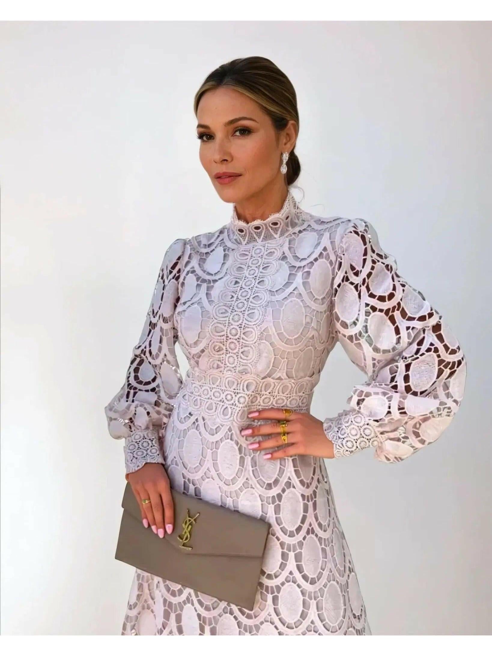 White lace midi dress with high neckline and long puff sleeves
