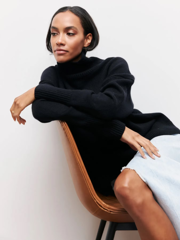 Black knitted turtleneck sweater with long sleeves and ribbed cuffs