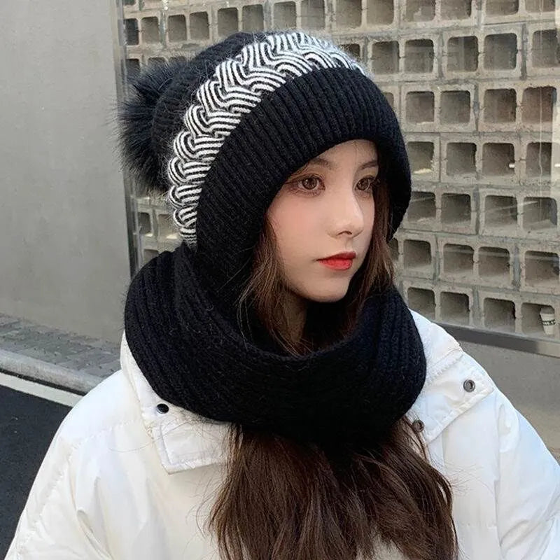 Black knit beanie and infinity scarf set with swirl ribbing and faux-fur pom-pom