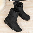 Women's black quilted mid-calf pull-on boots with side zipper and chunky tread