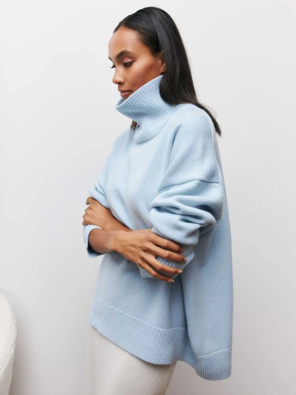 Light blue knitted turtleneck sweater with long sleeves and ribbed cuffs