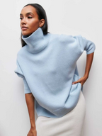 Light blue knitted turtleneck sweater with folded collar and ribbed cuffs