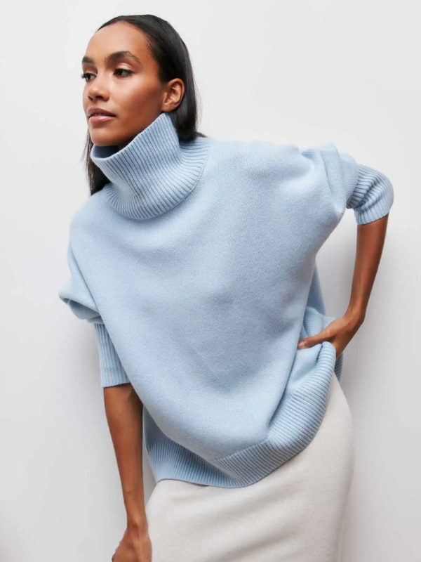 Light blue knitted turtleneck sweater with folded collar and ribbed cuffs