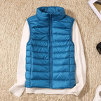 Blue quilted bodywarmer vest with full-zip and stand collar over white sleeves