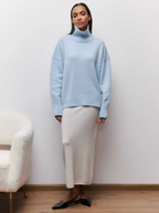 Light blue knitted turtleneck sweater with long sleeves and ribbed collar