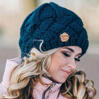 Dark blue textured knit beanie hat with small brown brand patch