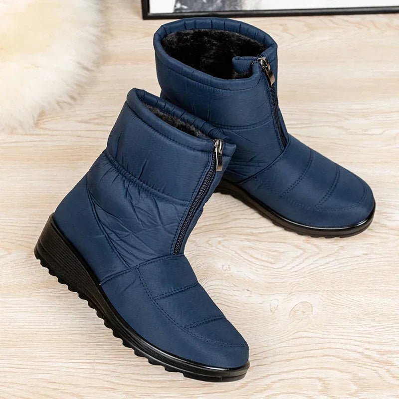 Women's blue quilted mid-calf pull-on boots with side zipper and thick tread