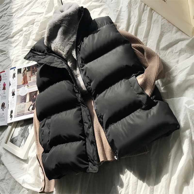 Black puffer bodywarmer with beige ribbed sleeves, zip front and stand collar