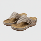 Women's wedge sandals pair in light taupe, perforated straps on tan wedge sole