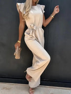 Beige wide-leg jumpsuit with flutter sleeves and waist-tie belt, side view