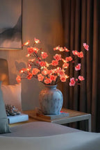 Cherry blossom LED centerpiece with pink flower lights on branches in blue speckled vase