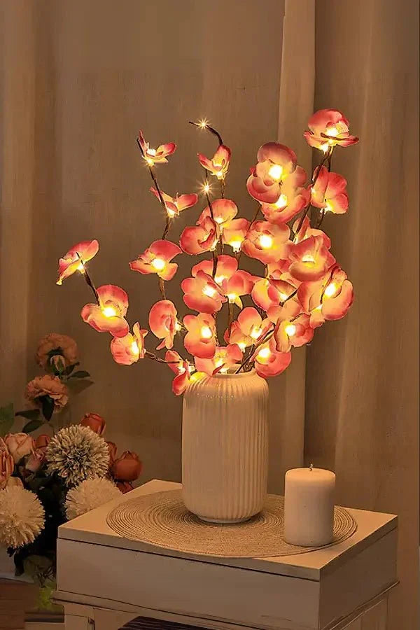 Cherry blossom LED centerpiece with pink flower-shaped lights in white vase