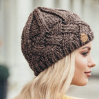 Brown cable-knit beanie hat with small brown brand patch