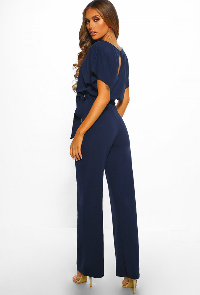 Navy blue high-waist jumpsuit with short cape sleeves and wide straight legs