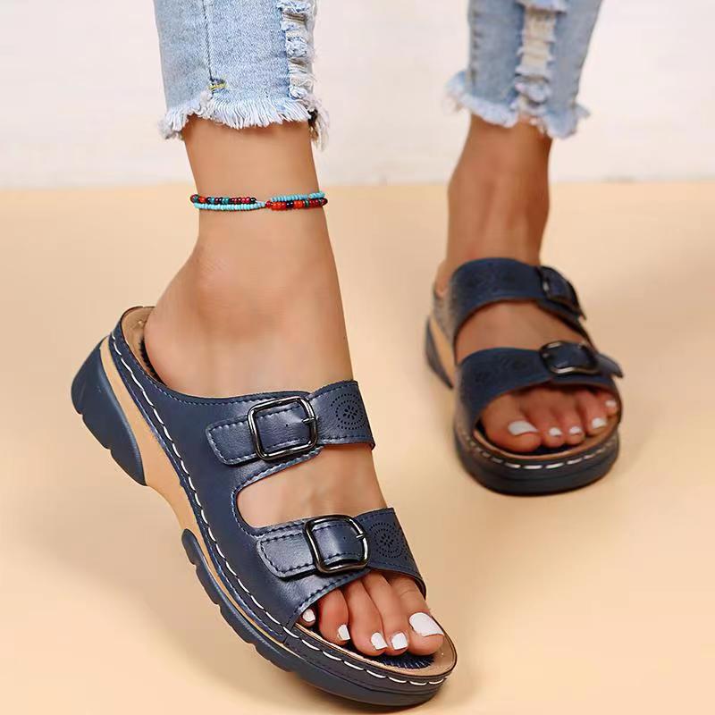 Navy double-buckle slip-on sandals with perforated straps and cushioned platform sole
