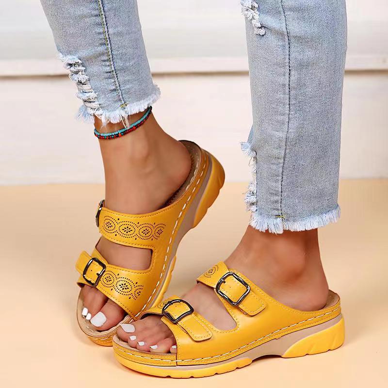 Yellow double-buckle slip-on sandals with perforated straps and cushioned platform sole