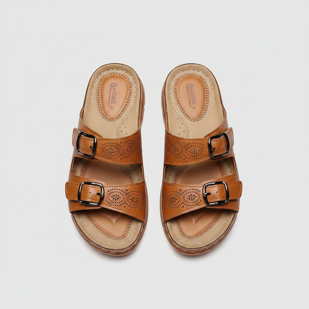 Tan double-buckle slide sandals with perforated leather straps and cushioned sole