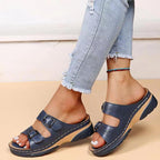 Navy double-buckle slip-on sandals with perforated straps and cushioned platform sole