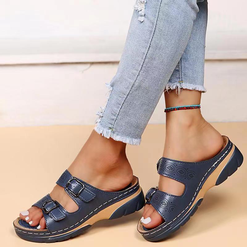 Navy double-buckle slip-on sandals with perforated straps and cushioned platform sole