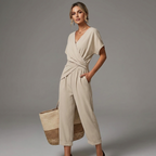 Women’s light beige jumpsuit with V-neck, short sleeves, wrap front tie waist, wide cropped legs