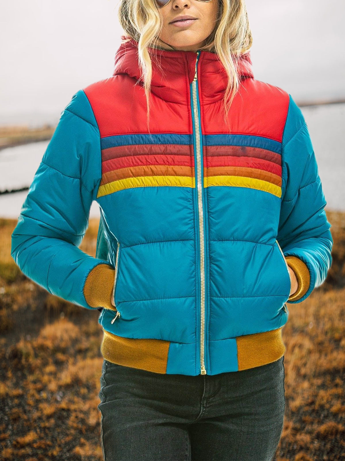 Waterproof rain coat front view with hood, zip front, teal padded jacket with rainbow stripes