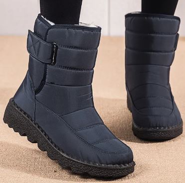 Women's navy quilted mid-calf boots with buckle strap and textured tread sole