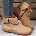 Women’s vintage-style ankle boots, tan/beige with contrast white stitching and side zipper.
